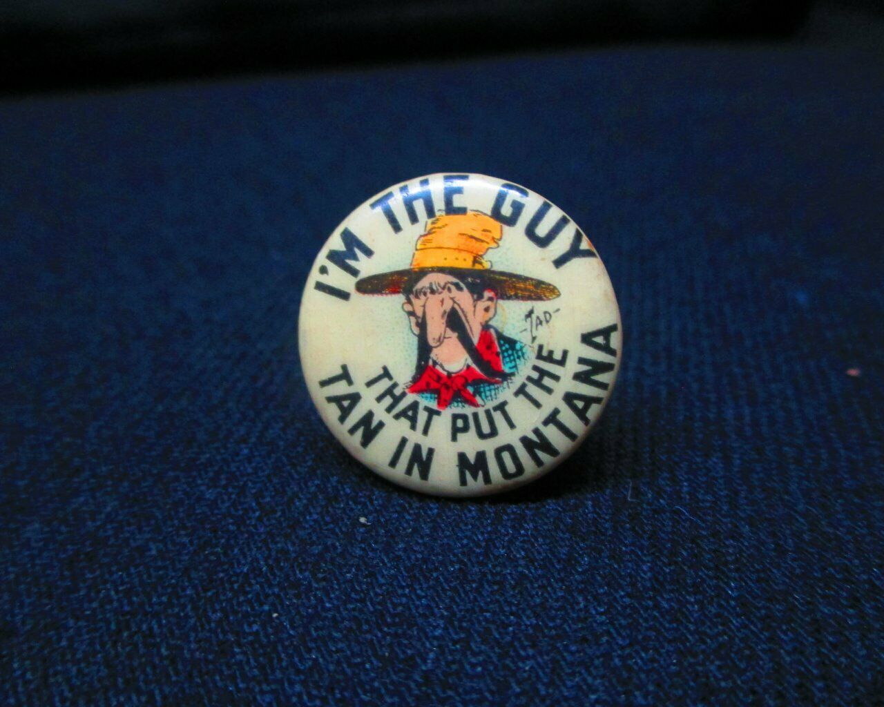 1910 Hassan Cigarette Pinback W/ Tad Art I'm The Guy That Put The Tan In Montana